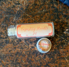 GLASS NEEDLE CASE WITH NEEDLEMINDER AND 2 #26 TAPESTRY NEEDLES